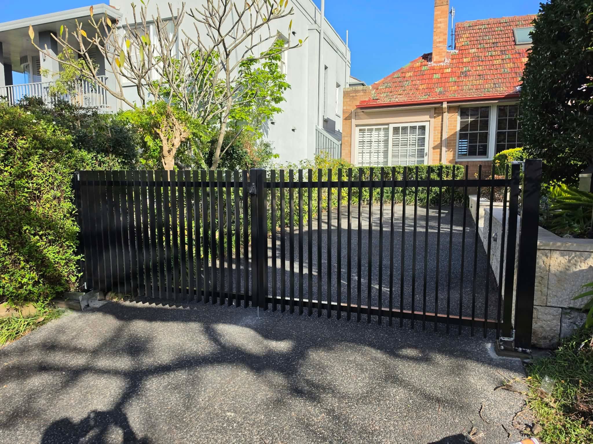 Black steel slat double driveway gate supplied and installed by Monfab at a residential property